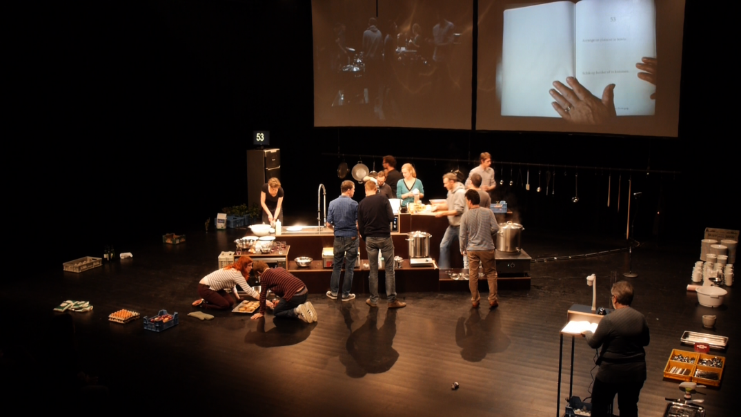 A group of people are cooking on stage. 